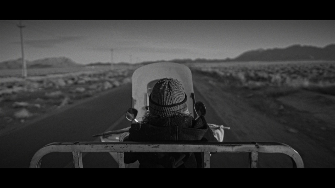 A person riding a motorbike down an open road